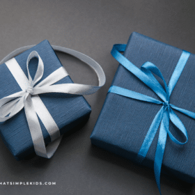 two gifts wrapped in blue wrapping paper on a dark gray background