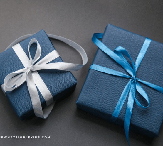 two gifts wrapped in blue wrapping paper on a dark gray background