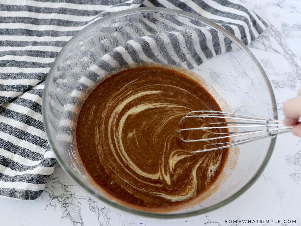 adding ingredients to a glass mixing bowl