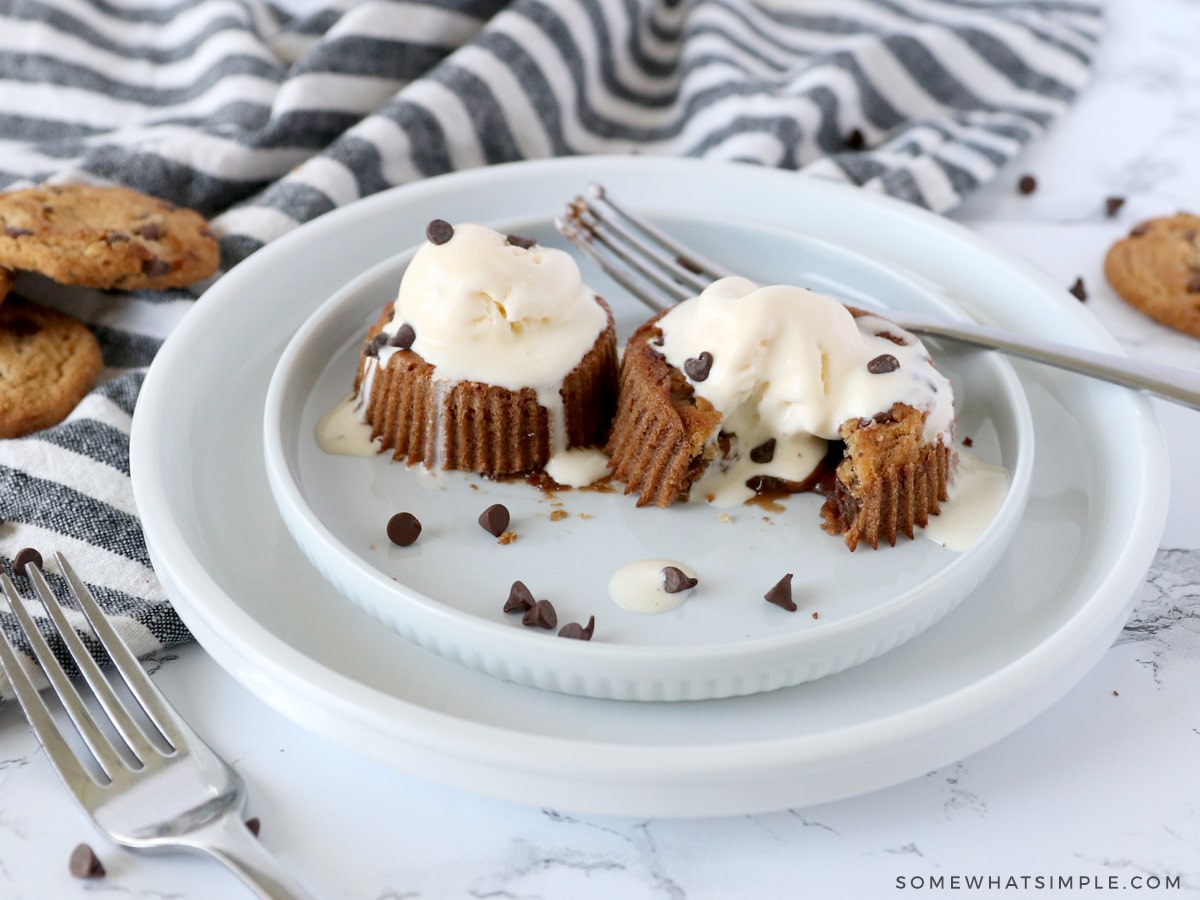 two chocolate lava cakes with scoops of ice cream on top