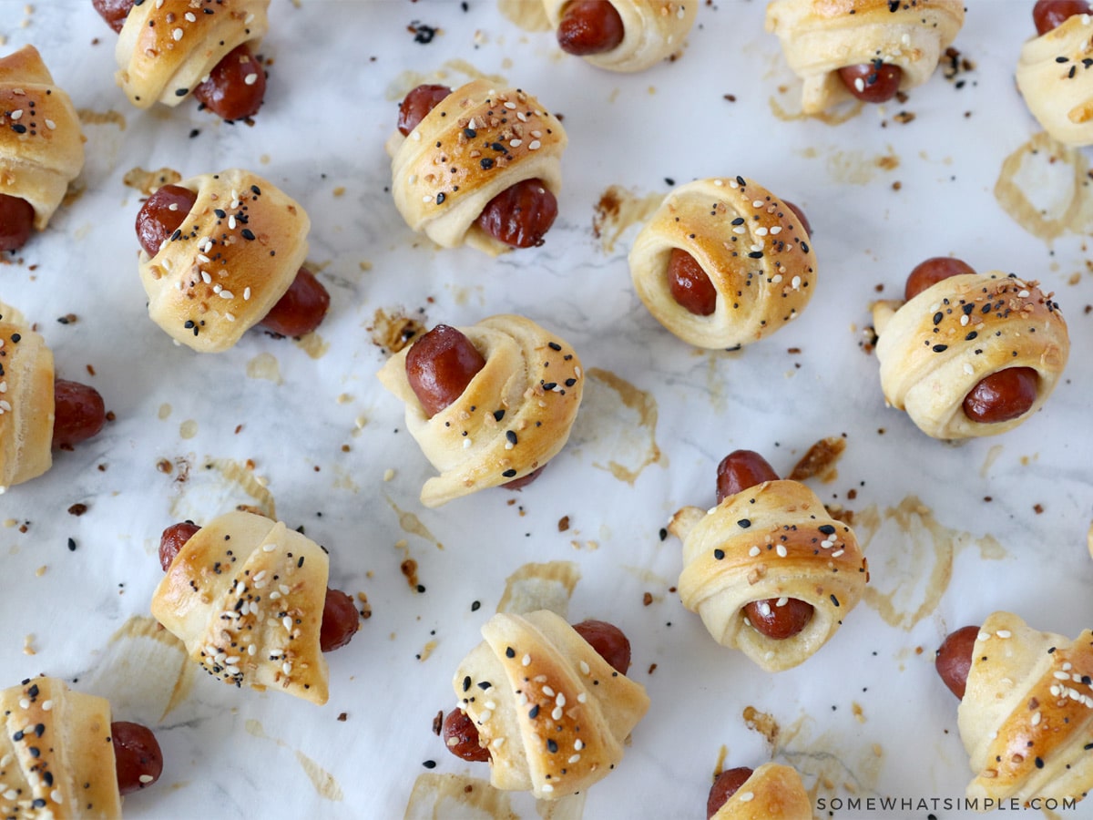 pigs in a blanket scattered around a counter