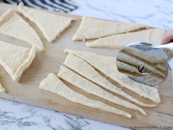 cutting crescent dough into smaller triangles