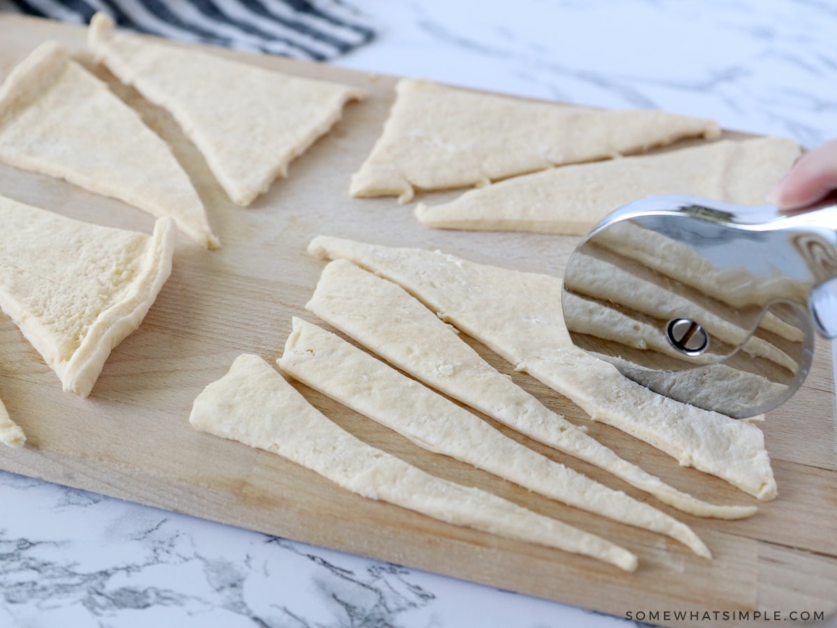 cutting crescent dough into smaller triangles