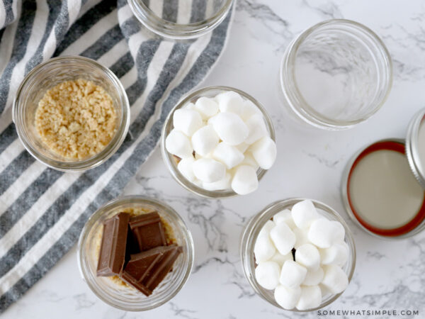 layering smore ingredients in small glass jars