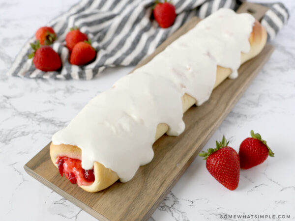 finished cream cheese strawberry bread on a brown cutting board