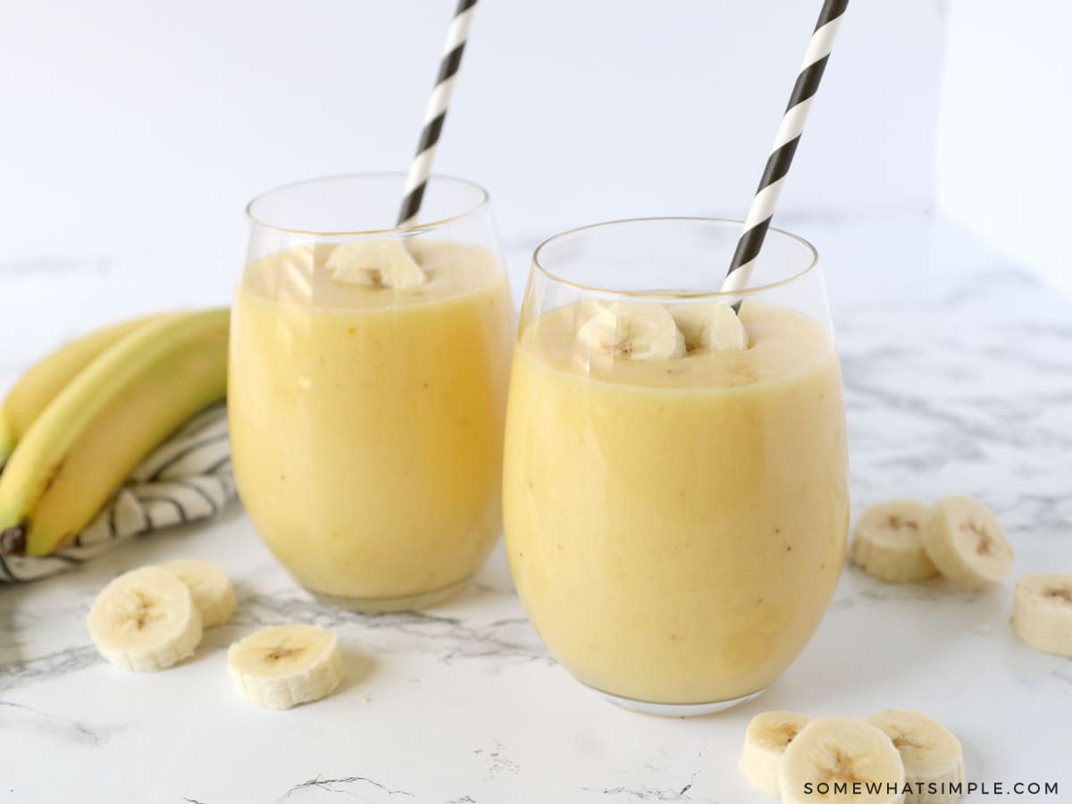 2 glasses filled with a banana smoothie