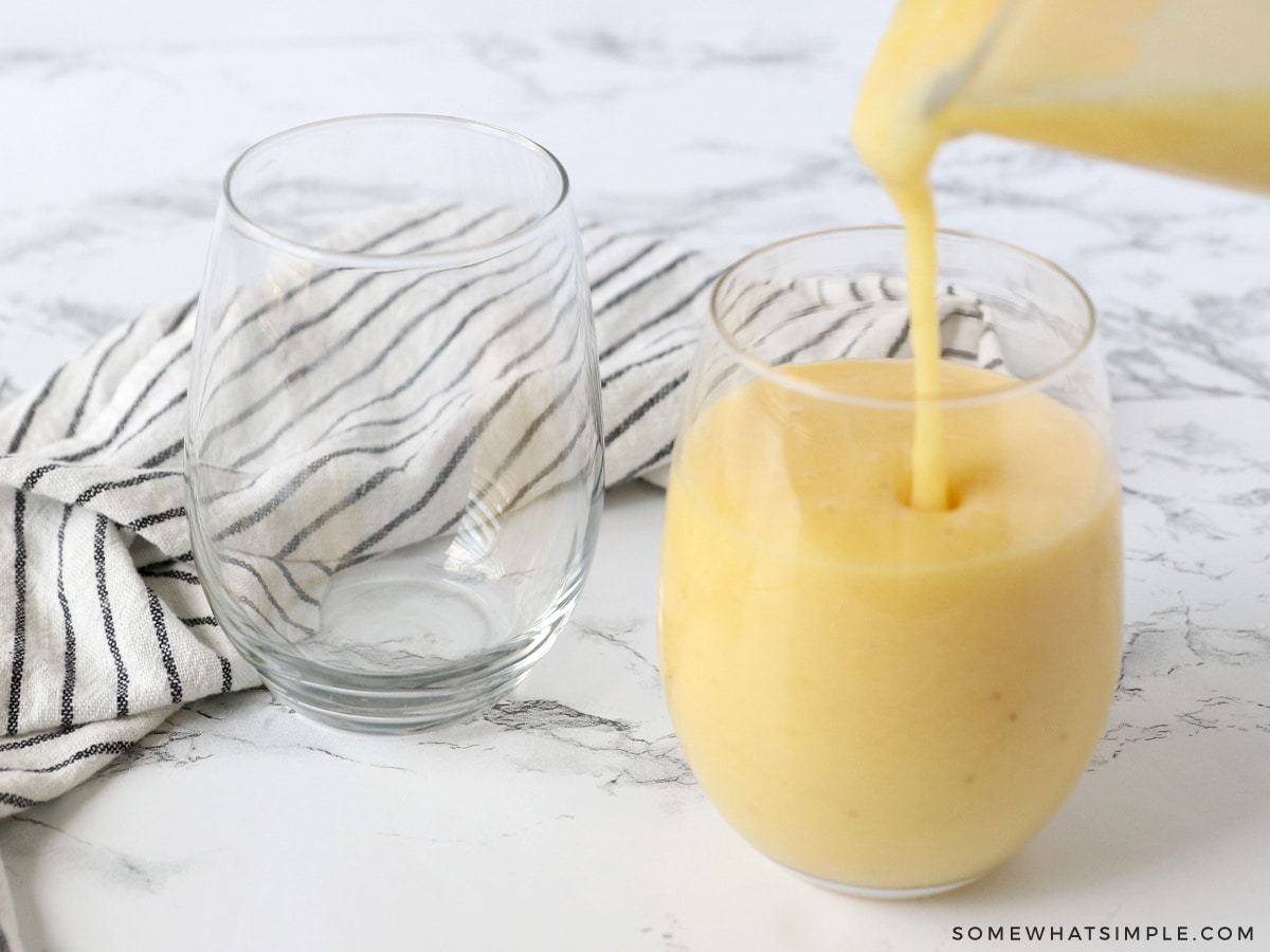 banana smoothie being poured into glass cups