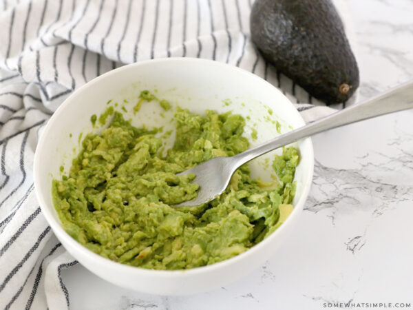 mashing an avocado with a fork