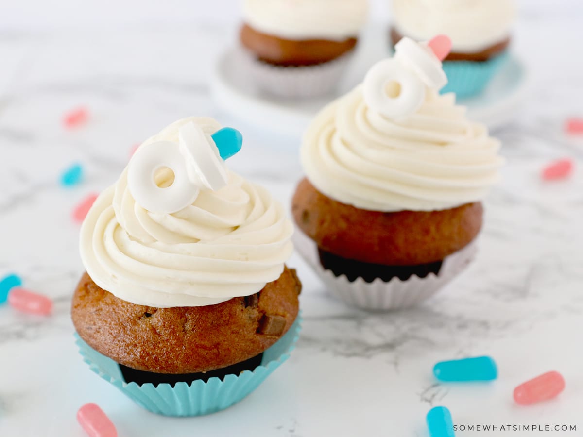 adding a candy pacifier to the op of some cupcakes