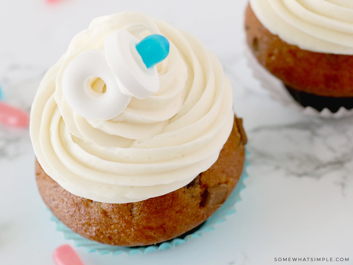 close up of a candy pacifier on a cupcake
