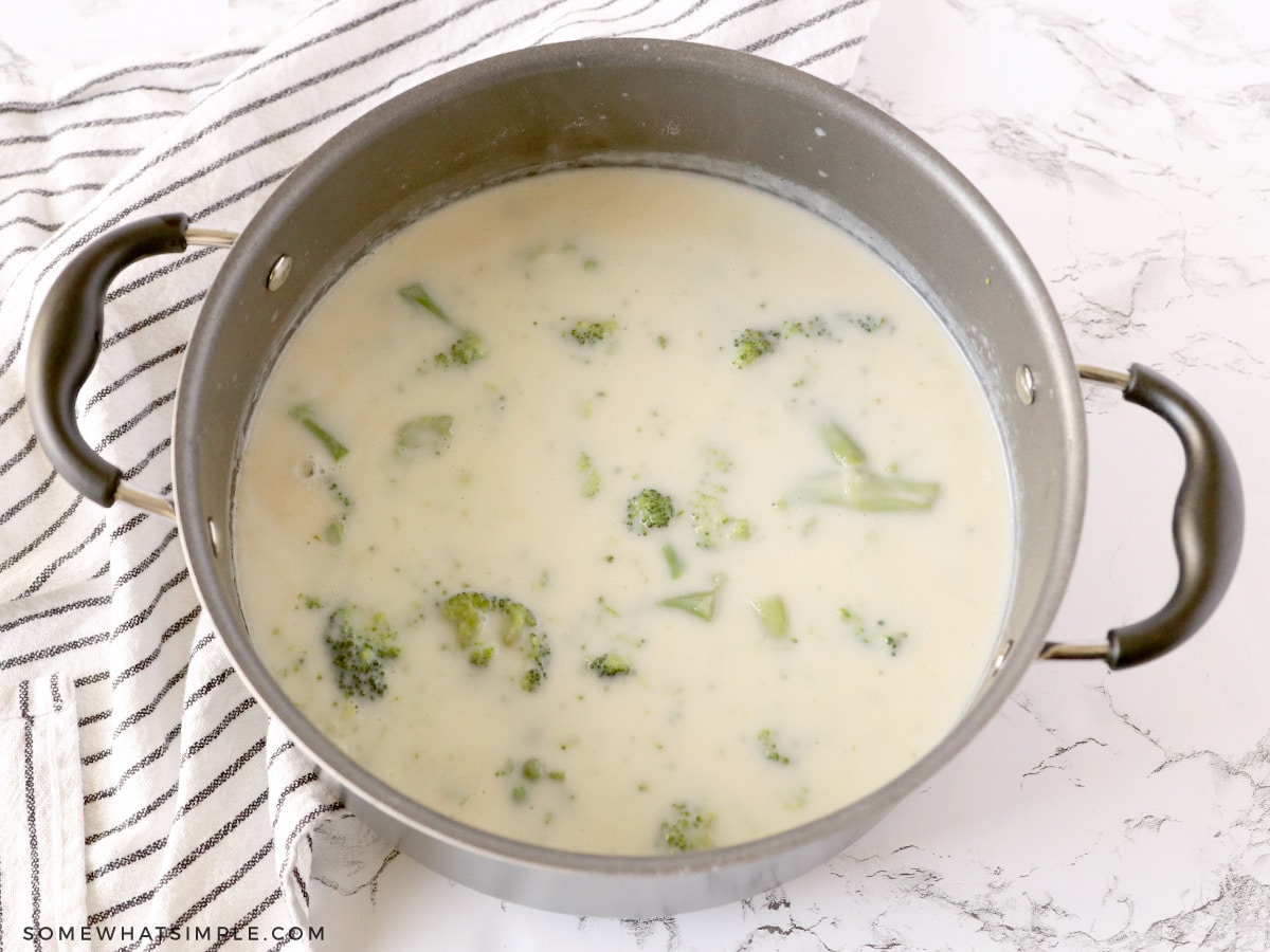 adding milk to a broccoli soup