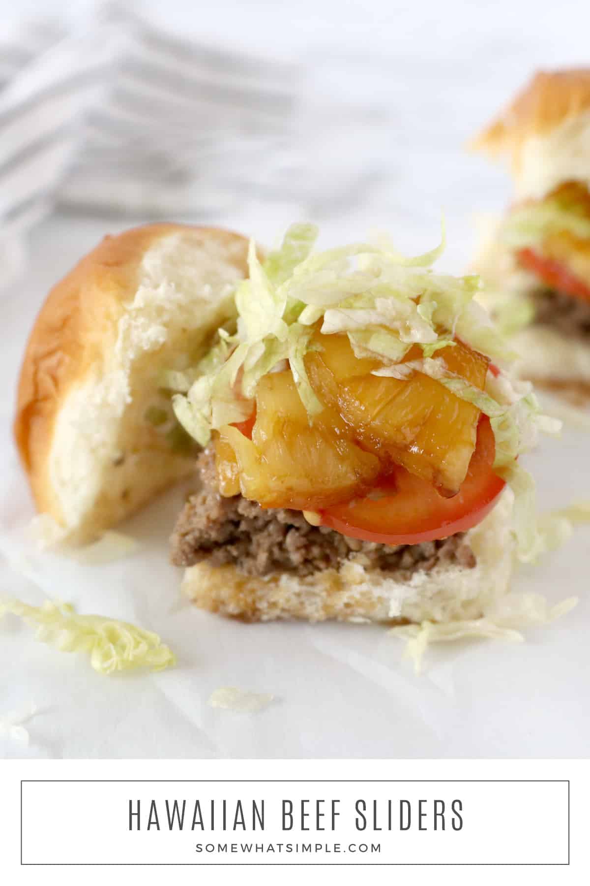 Tender juicy beef with grilled pineapple and teriyaki sauce sandwiched together on sweet Hawaiian rolls - these Hawaiian Beef Sliders are simple to make and they taste AMAZING! via @somewhatsimple