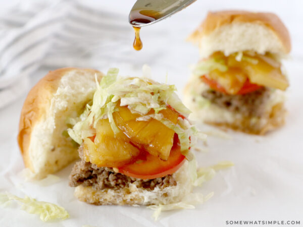 drizzling a slider with teriyaki sauce