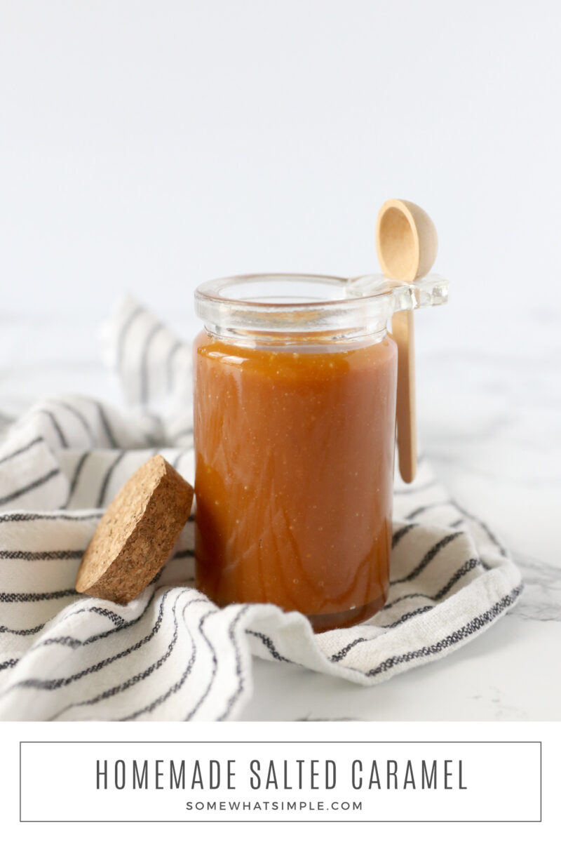 long image of a salted caramel sauce in a jar with wooden spoon