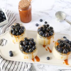 salted caramel pudding parfaits in small glass dishes on a serving tray