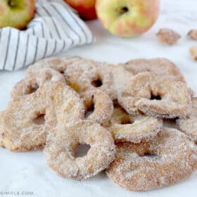 fried apple rings with cinnamon and sugar on a white plate