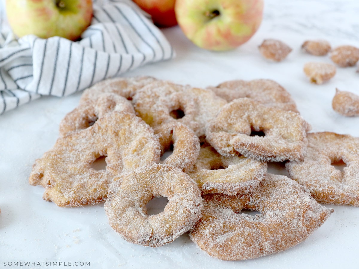 fried apple rings with cinnamon and sugar on a white plate