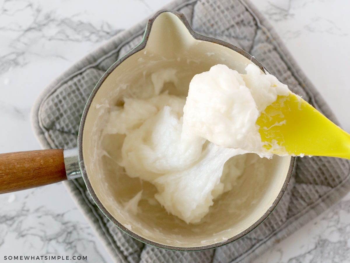 mixing coconut oil with soap shavings in a sauce pan