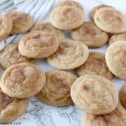 3 dozen snickerdoodle cookies scattered about on the counter