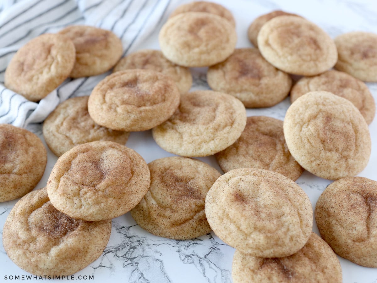 3 dozen snickerdoodle cookies scattered about on the counter