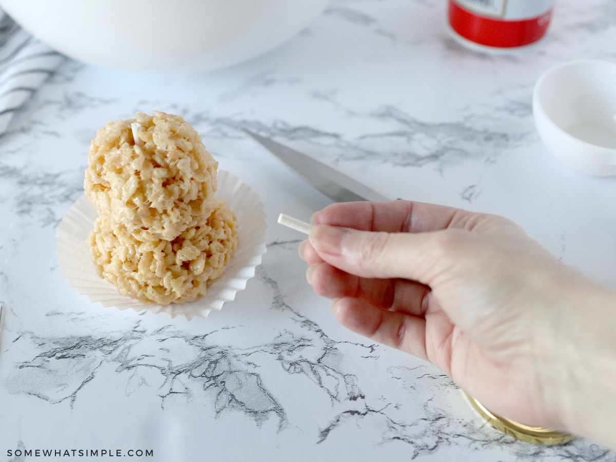 making rice krispies into 2 balls to make a snowman