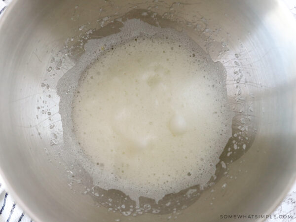 adding souffle mixture to a metal mixing bowl