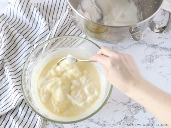 mixing sugar into a batter for lemon souffles