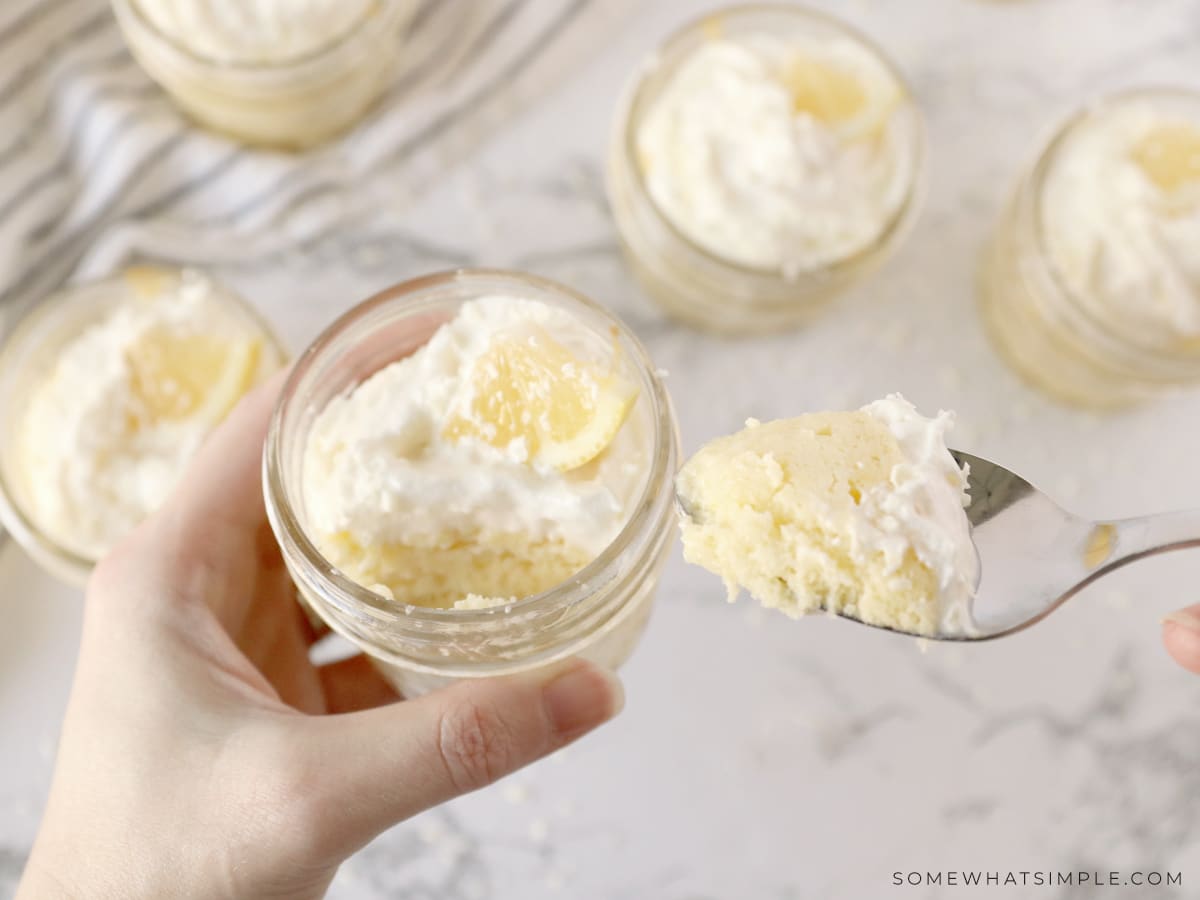 holding a glass dish with lemon dessert