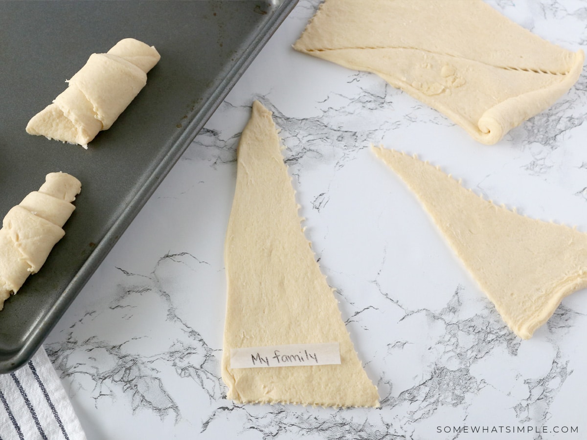 adding strips of paper to a crescent roll