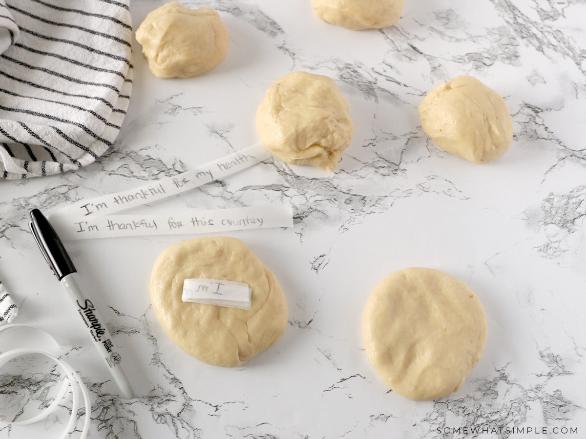 adding strips of paper to raw dough