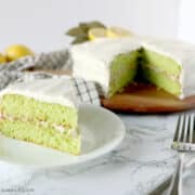 lime cake cut and served on a white plate