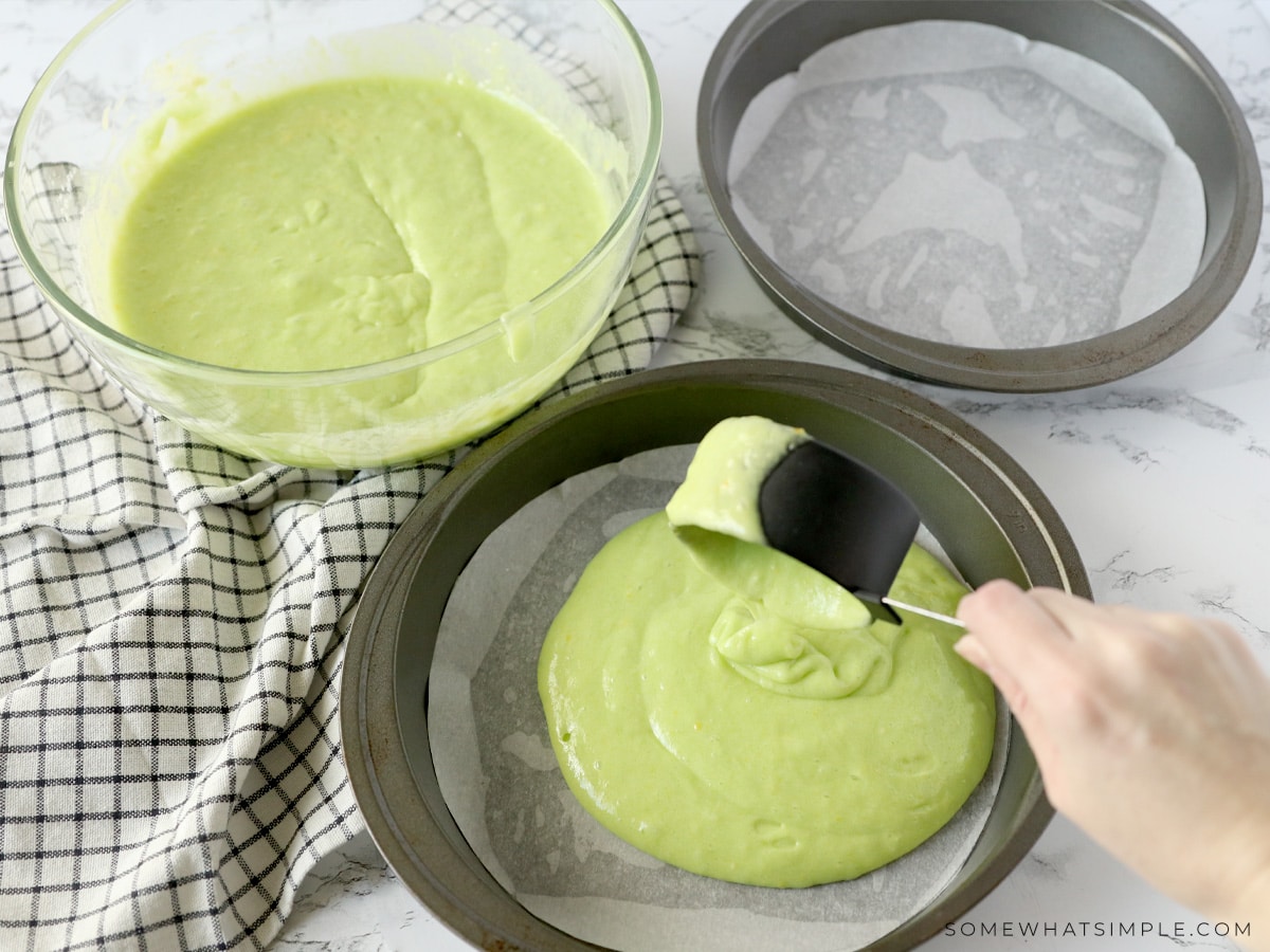 putting lime cake mix into 2 cake pans