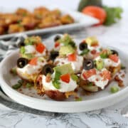 plate with mini potato poppers arranged with toppings