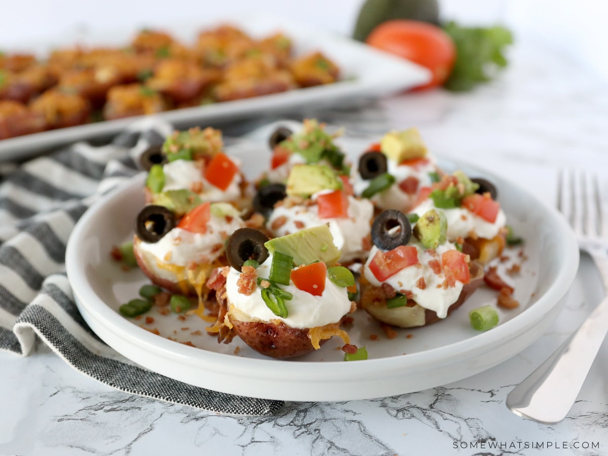 plate with mini potato poppers arranged with toppings