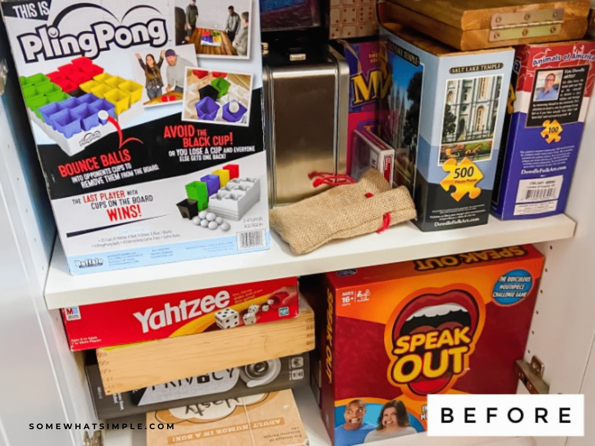 a before image of what a crowded game cupboard