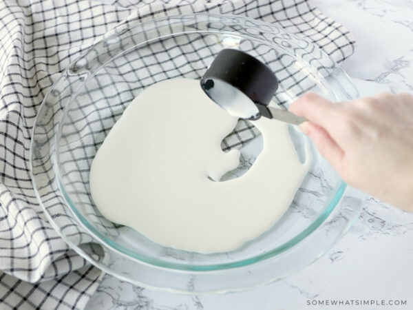 adding heavy cream to the bottom of a pan