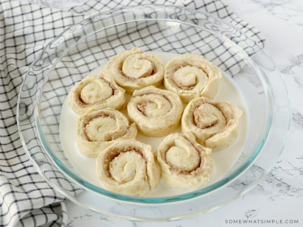 raw orange roll dough in a round pan