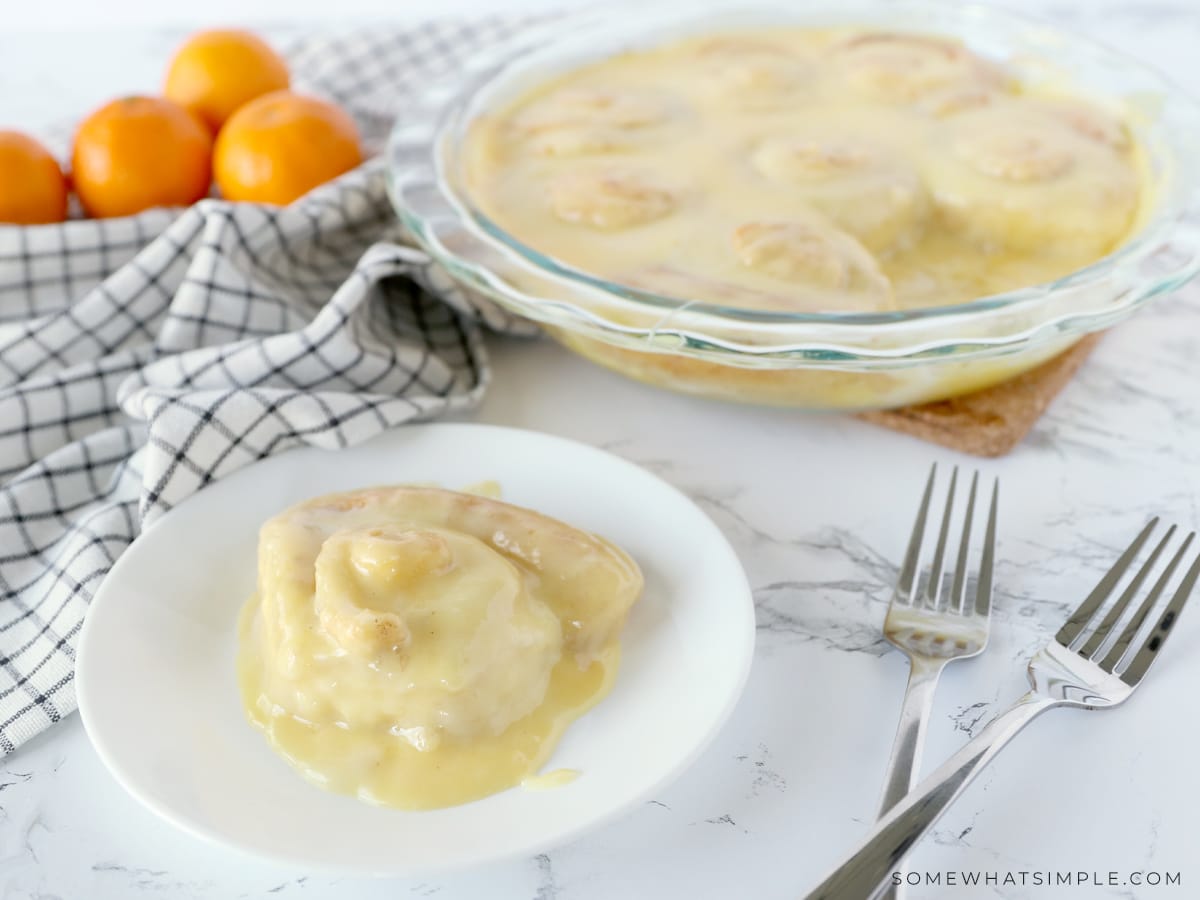 30 minute orange rolls on a plate with a bowl of oranges