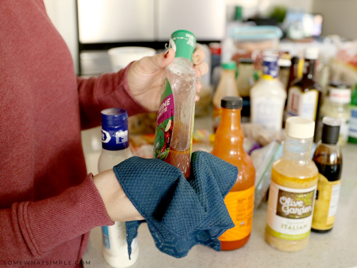 wiping down the outside of condiment bottles