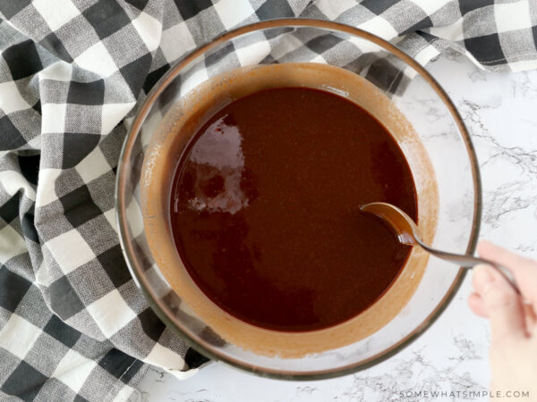 mixing a chocolate brownie mix in a glass bowl