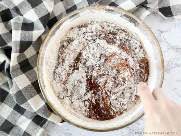 adding flour to brownie mixture