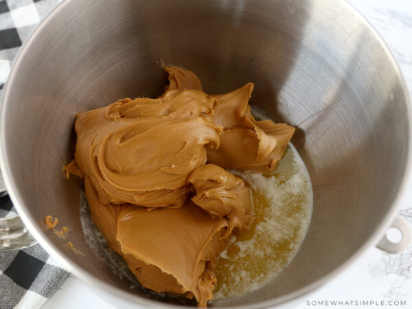 adding peanut butter to a mixing bowl