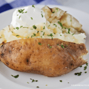 plated baked potato with sour cream and chives