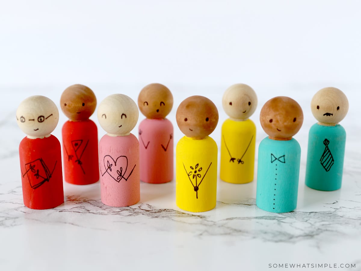 wooden spool dolls lined up and ready to play