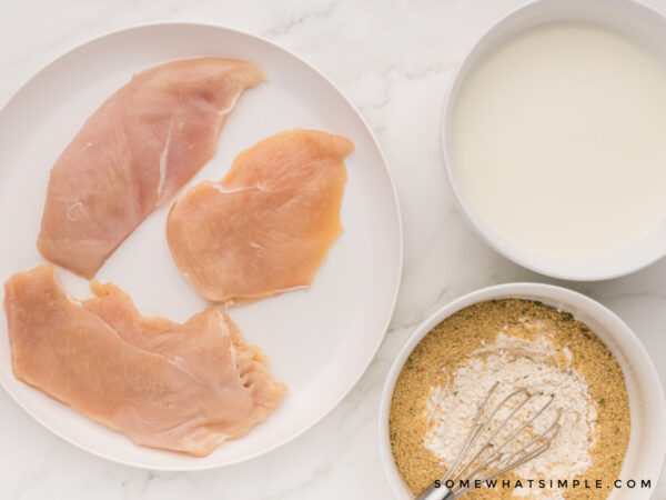 Chicken sandwich ingredients laid out on a white counter