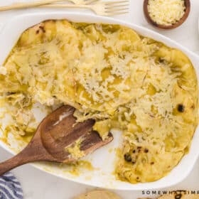 finished enchilada casserole with wooden serving spoon