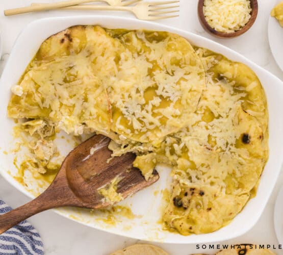 finished enchilada casserole with wooden serving spoon