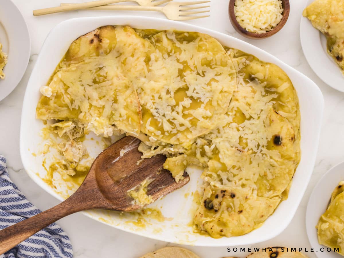 finished enchilada casserole with wooden serving spoon