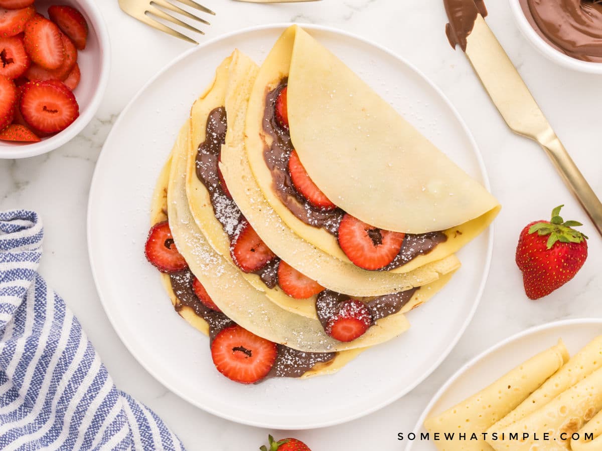 plated crepes with strawberries and nutella