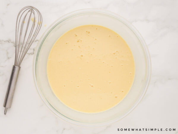 resting crepe batter in a glass bowl